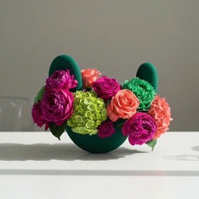 Modern sculptural wedding floral centerpiece with bold colors and organic shapes